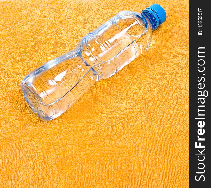 Water in bottle on orange background, fitness concept. Water in bottle on orange background, fitness concept
