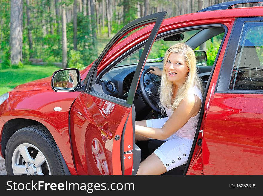Beautiful Woman Driver In Red Shiny Car