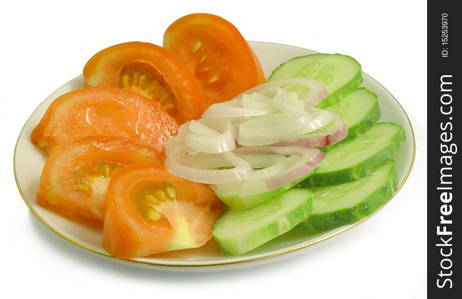 Slices of tomato, cucumber and onion rings on a porcelain platter, vegetables on white background. Slices of tomato, cucumber and onion rings on a porcelain platter, vegetables on white background