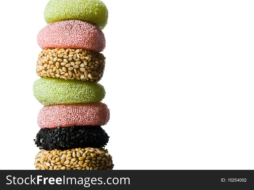 Stack of assorted candies on white background