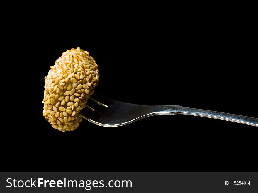 Sweet on a fork isolated on black background