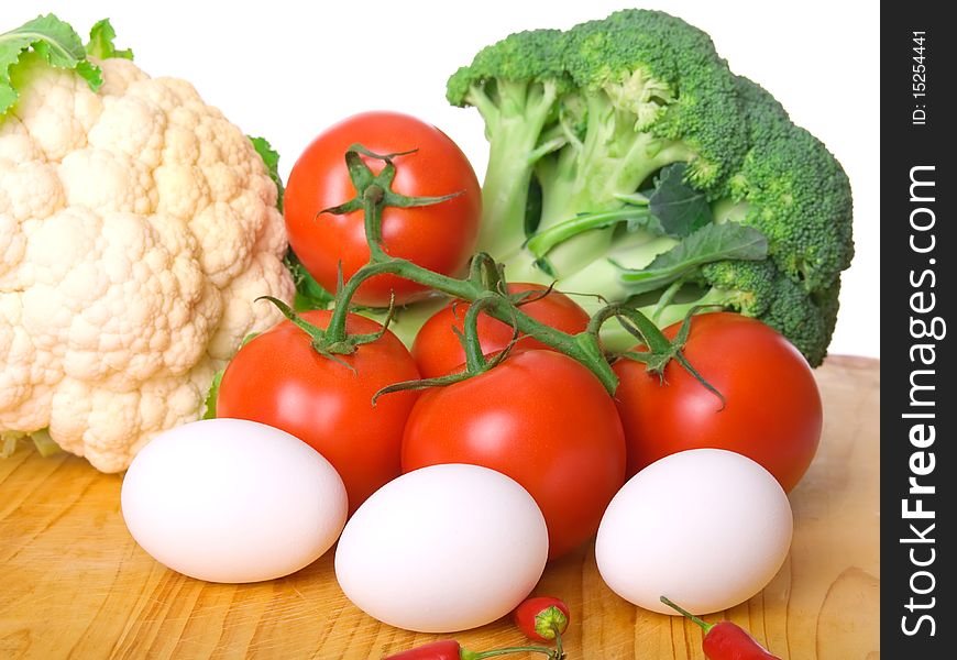 Fresh vegetables: Cauliflower, tomatoes, broccoli on white background