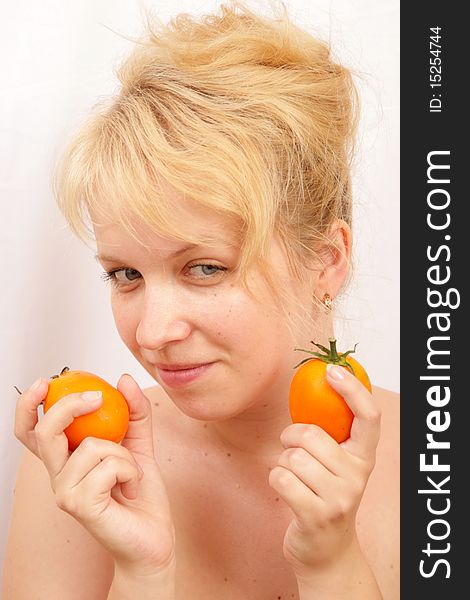 blond girl with orange tomatos. blond girl with orange tomatos