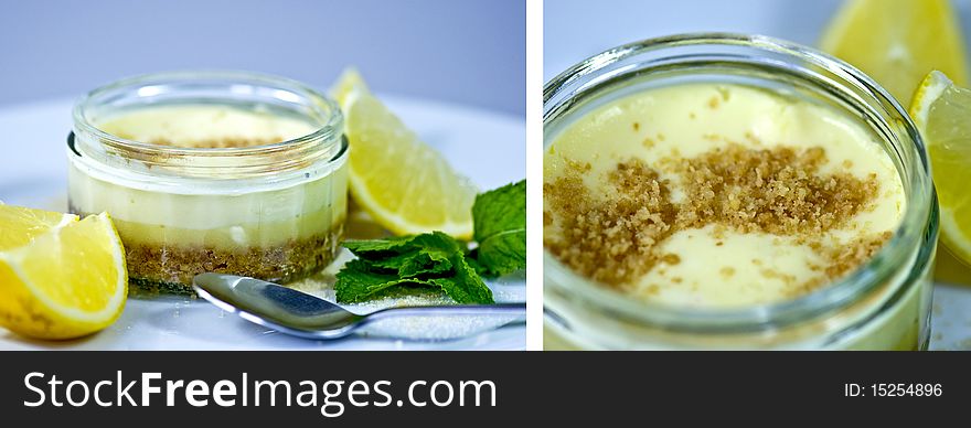 Lemon cheesecake in a ramekin decorated with lemon quarters, brown sugar and mint leaves