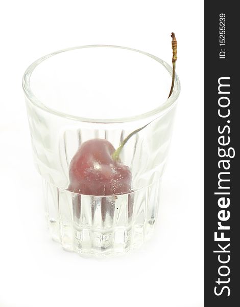 Sweet cherry in a glass over white