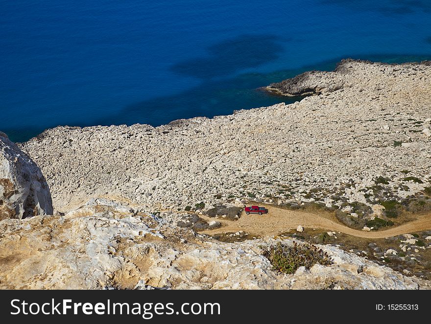 Shoreline of rocky desert at the foot of the mountain at the Cape El Greco, Cyprus. Shoreline of rocky desert at the foot of the mountain at the Cape El Greco, Cyprus