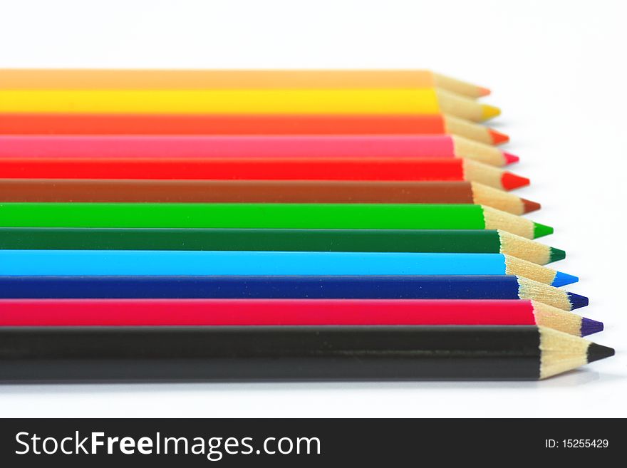Close up of color pencils with different color over white background.