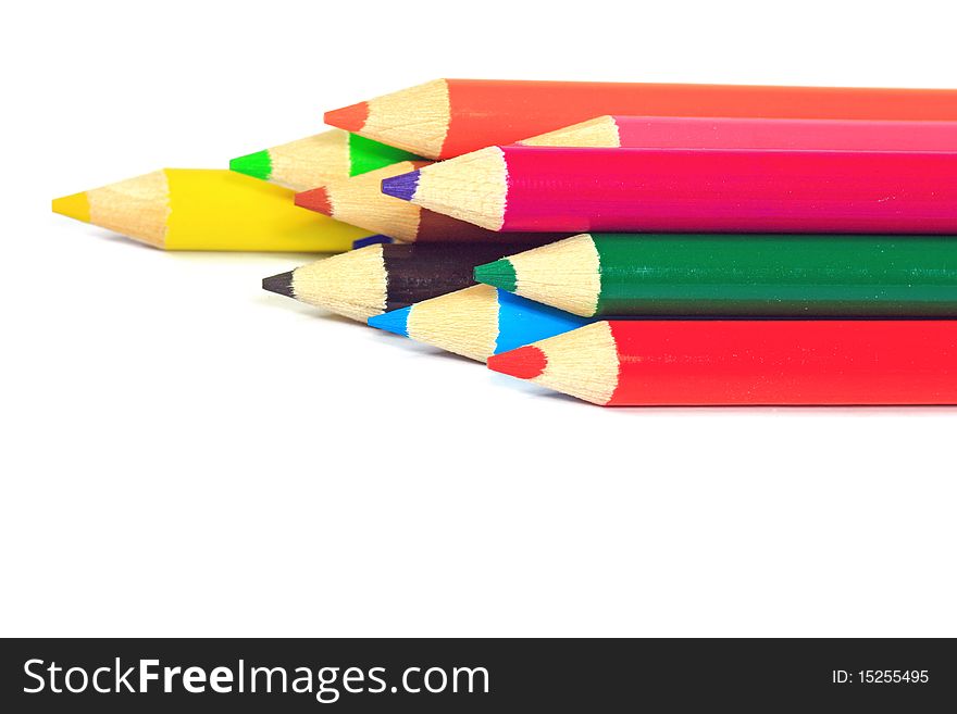 Close up of color pencils with different color over white background.