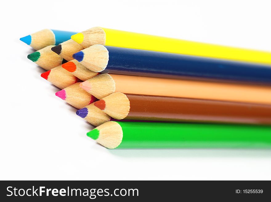 Close up of color pencils with different color over white background.