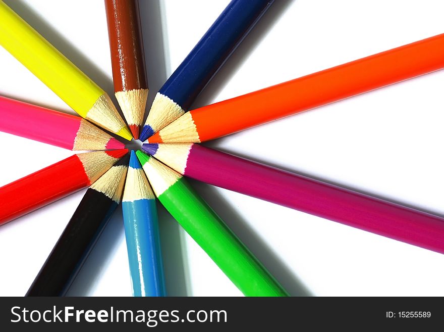 Close up of color pencils with different color over white background.