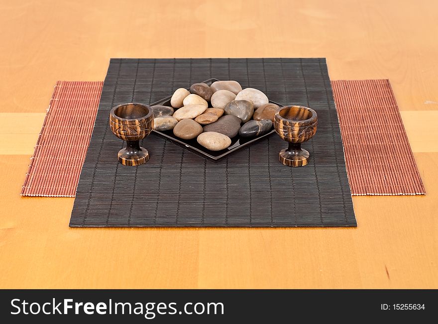 Rocks and Tea Candle Holders on Bamboo Mat. Rocks and Tea Candle Holders on Bamboo Mat