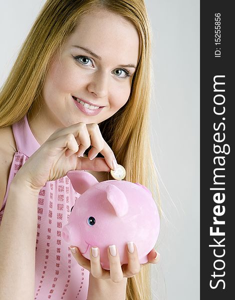 Portrait of woman with a piggy bank