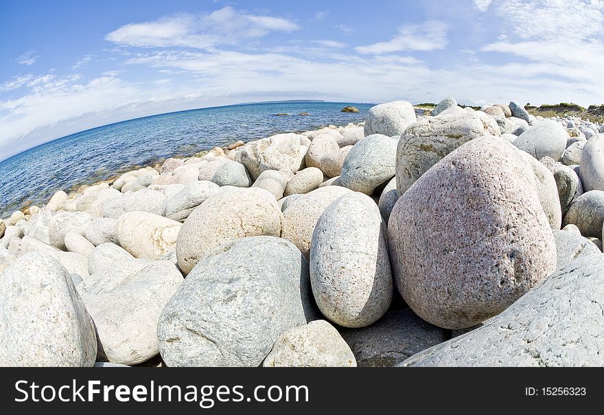A beach filled with gravels of various sizes. A beach filled with gravels of various sizes.