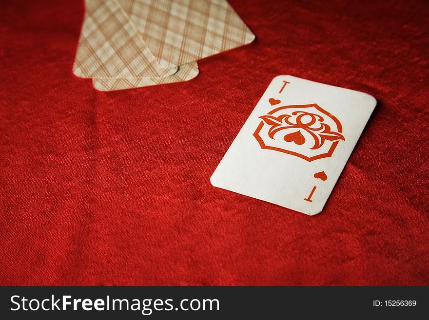 The vintage poker cards on red table
