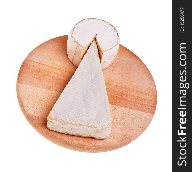 Two camembert cheese pieces over wooden board. Two camembert cheese pieces over wooden board.