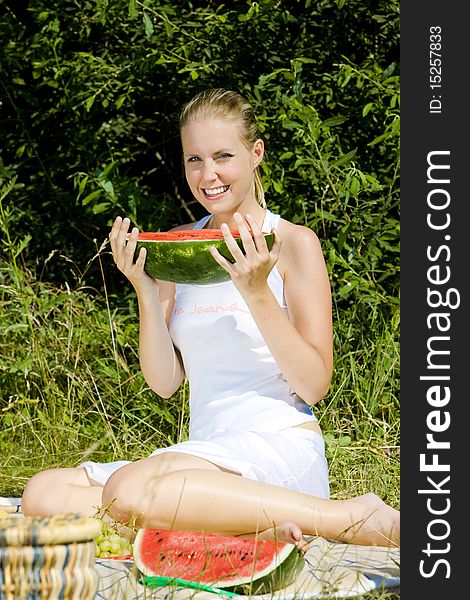 Woman with melon at a picnic. Woman with melon at a picnic