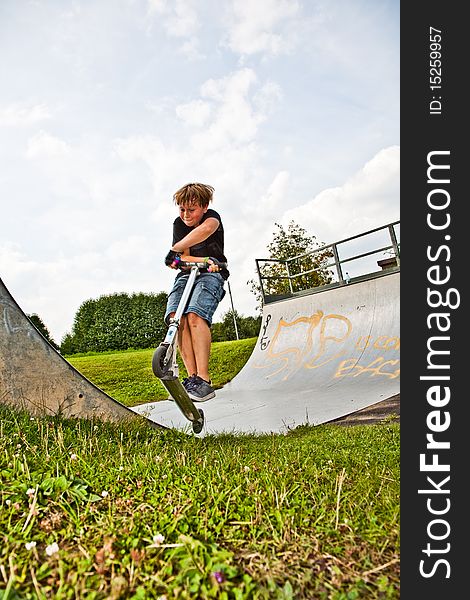 Child With Scooter In Halfpipe