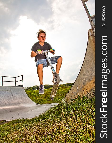 Child With Scooter In  Halfpipe