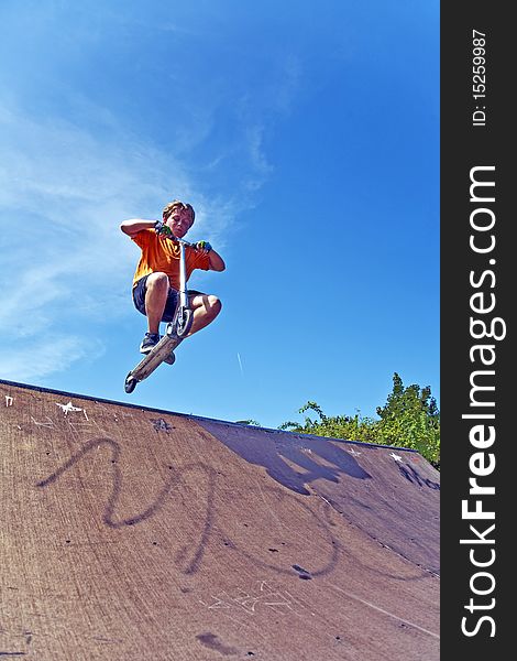 Boy With Scooter At Skate Park