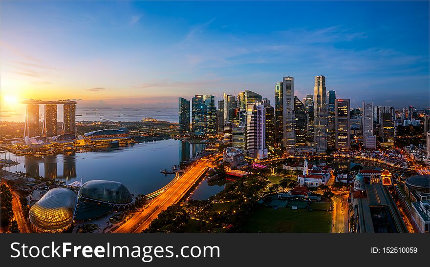 Singapore city and sunrise sky in harbour side view of hotel windows