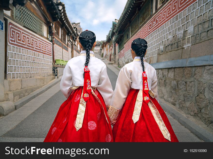 Korean lady in Hanbok or Korea dress and walk in an ancient town and Gyeongbokgung Palace in seoul, Seoul city, South Korea