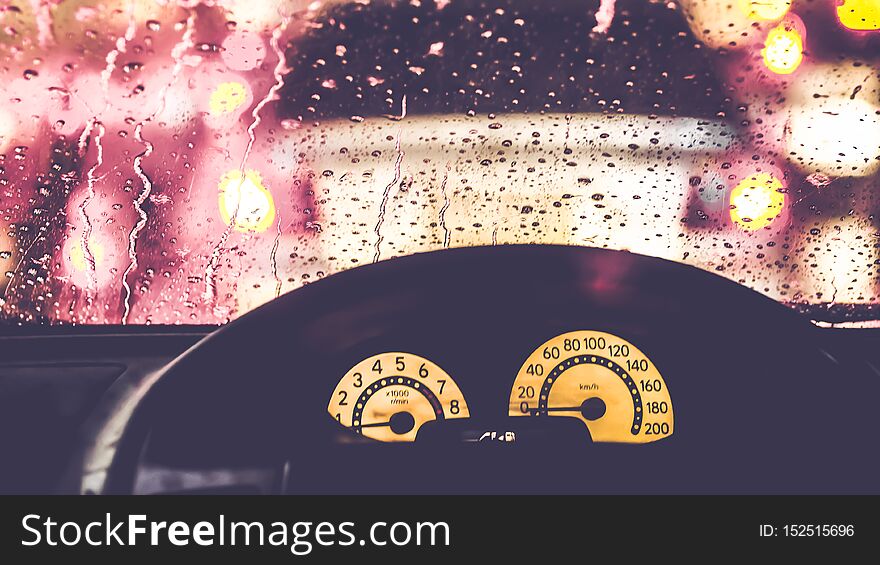 Car driving in rain and storm abstract background. Blurry car silhouette seen through snowy and wet windscreen with bokeh light . Car driving in rain and storm abstract background. Blurry car silhouette seen through snowy and wet windscreen with bokeh light