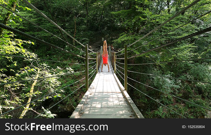 Woman in wooden suspension bridge