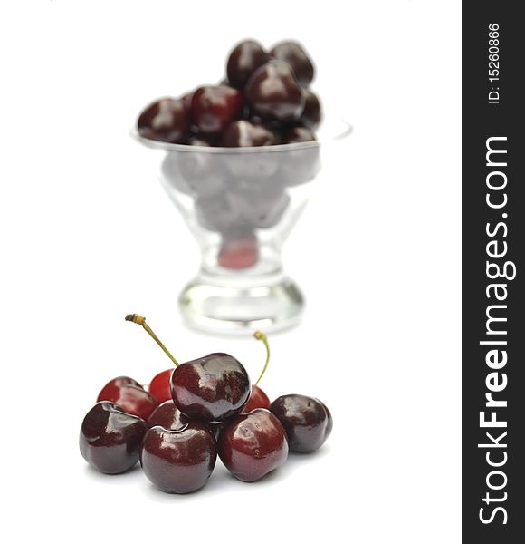 Closeup of ripe juicy cherries with glass bowl. Closeup of ripe juicy cherries with glass bowl