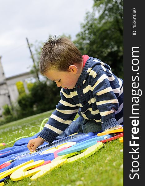 Caucasian preschooler playing educational games in nature. Caucasian preschooler playing educational games in nature