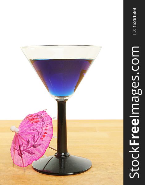 Blue cocktail in a glass with umbrella