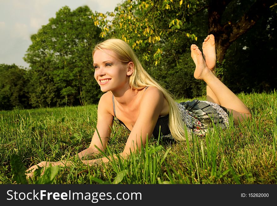 Beautiful woman lying on a green meadow. Beautiful woman lying on a green meadow