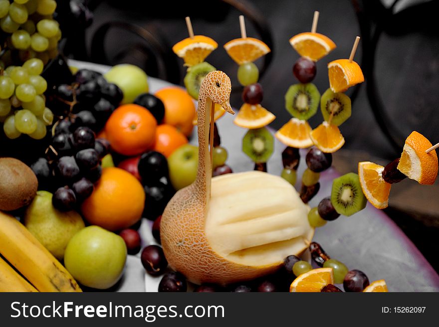 Fruit plate with bananas,kiwis, pineapples, apples, grapes