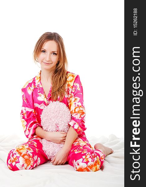 Sweet Young Girl In Pink Pajamas On Bed