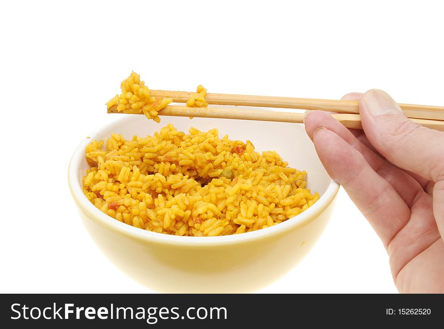 Closeup of a hand holding chopsticks with a bowl of rice. Closeup of a hand holding chopsticks with a bowl of rice