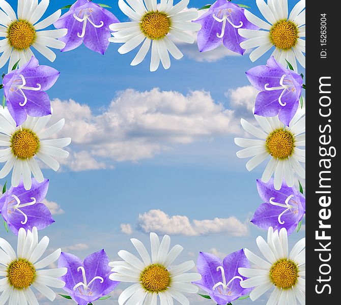 Frame of flowers on a background of cloudy sky
