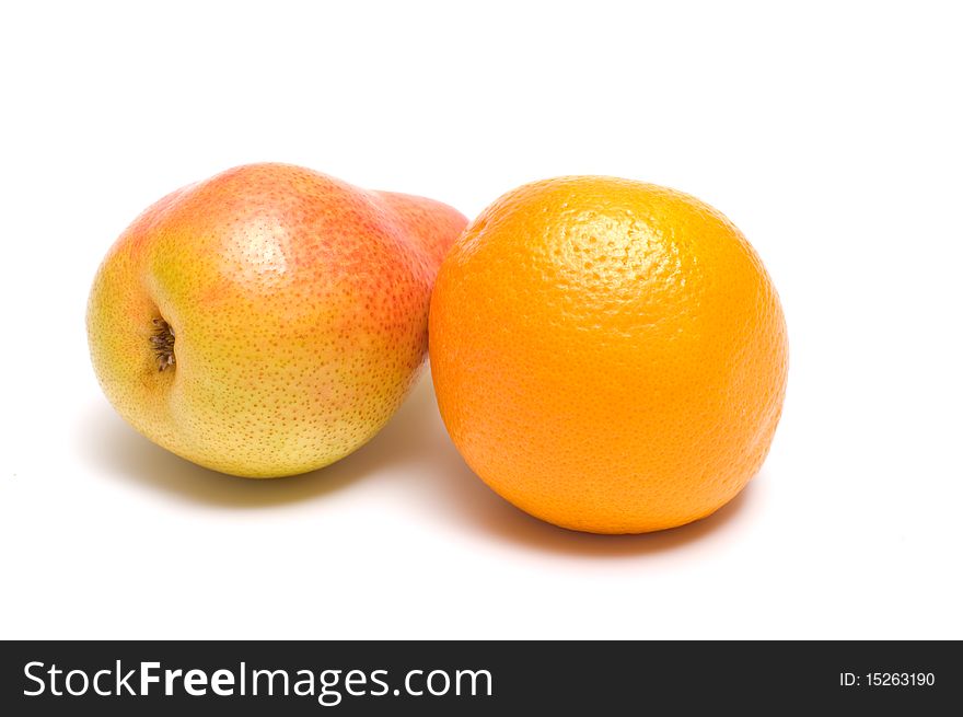 Pear and orange close up it is isolated on a white background. Pear and orange close up it is isolated on a white background.