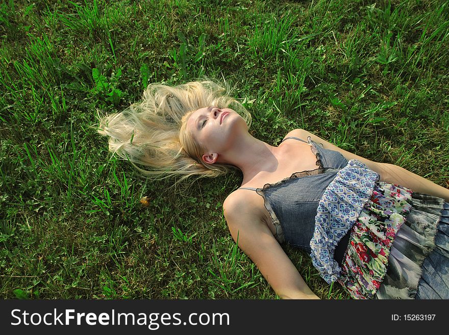 Beautiful woman lying on a green meadow. Beautiful woman lying on a green meadow