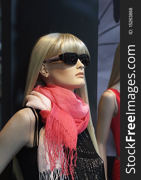 Dummy in a showroom with a pink scarf. Dummy in a showroom with a pink scarf