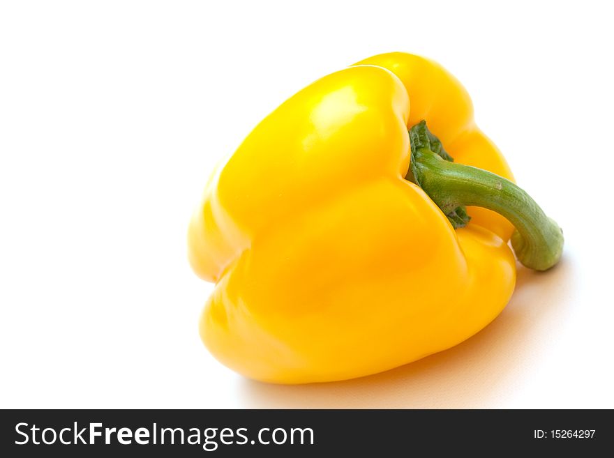 Fresh yellow paprika on white table isolated. Fresh yellow paprika on white table isolated