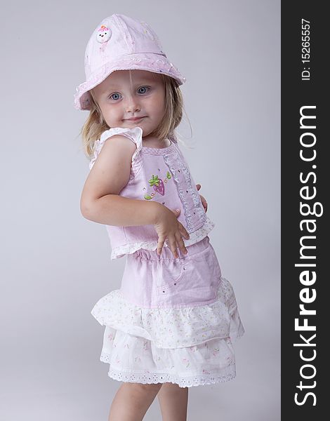 Little girl in pink dress possing like a fashion model. Little girl in pink dress possing like a fashion model