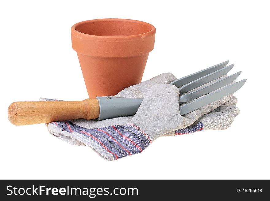 Rake for removal of weeds and a glove for work in a garden.