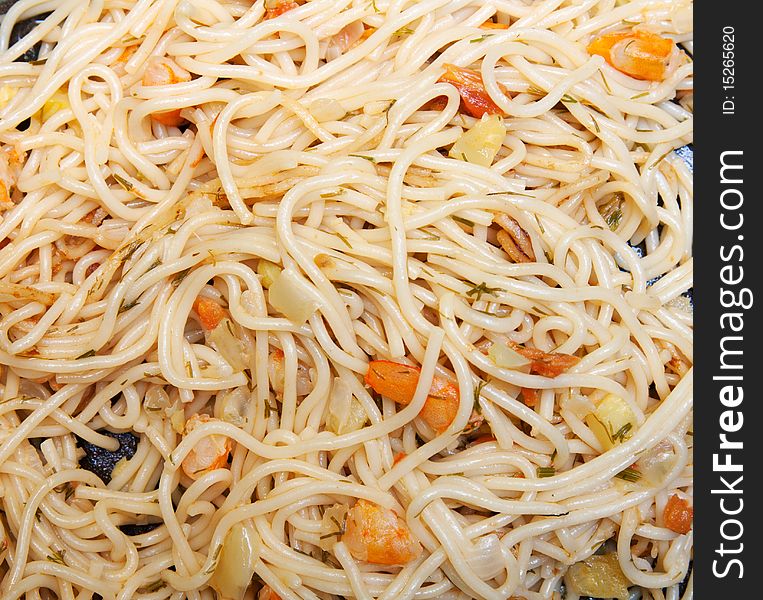 Spaghetti background with prawn and vegetable on black plate