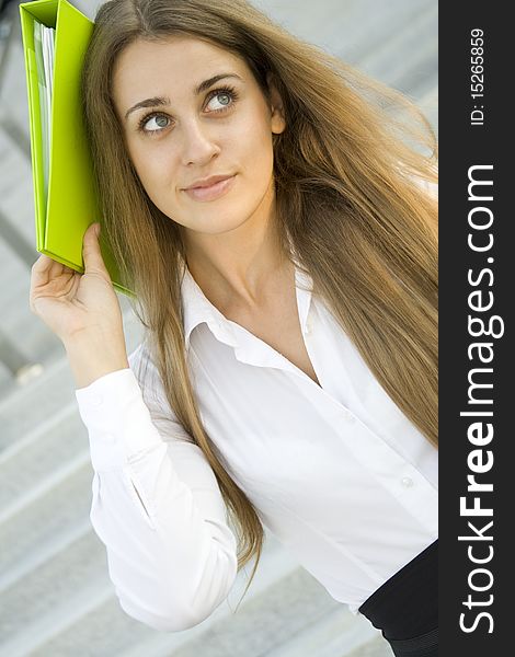 Attractive young businesswoman smiling with a green folder. Attractive young businesswoman smiling with a green folder.