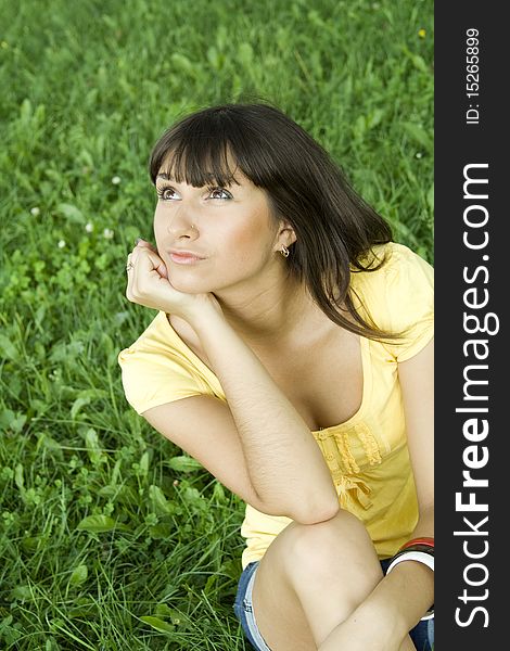 Young woman pensive outdoors in the park. Young woman pensive outdoors in the park