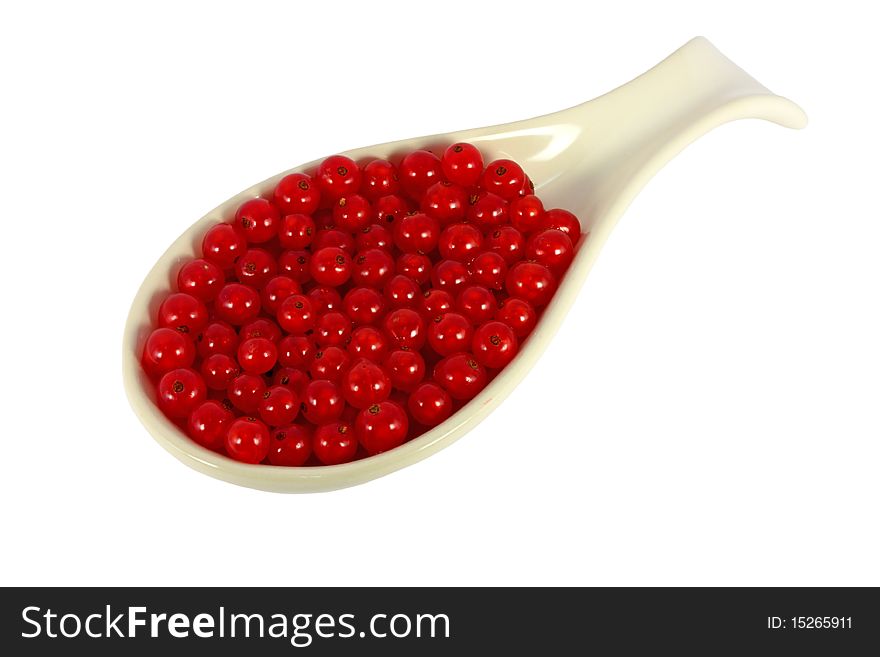 Spoon full of red currants isolated on white