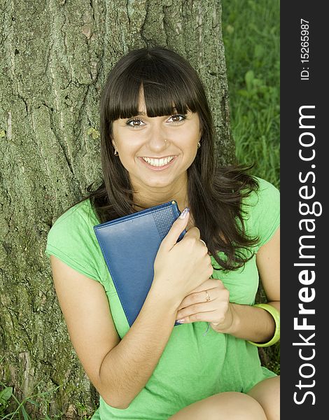 Female in a park with a notebook