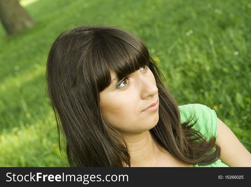 Young woman pensive outdoors in the park. Young woman pensive outdoors in the park