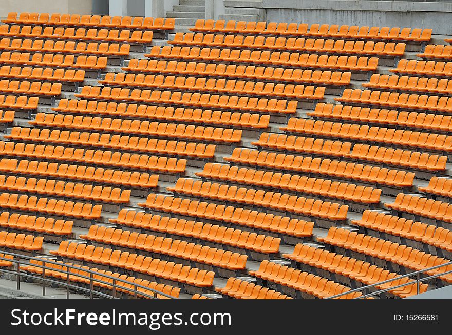 Empty orange seat in football stadium