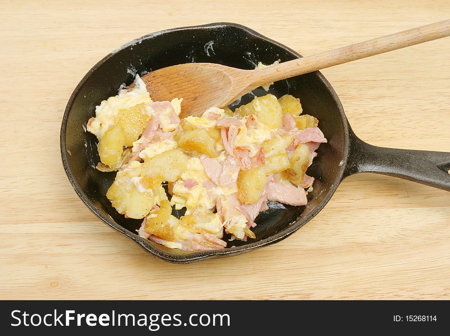 Fried potato, ham and eggs in a pan. Fried potato, ham and eggs in a pan