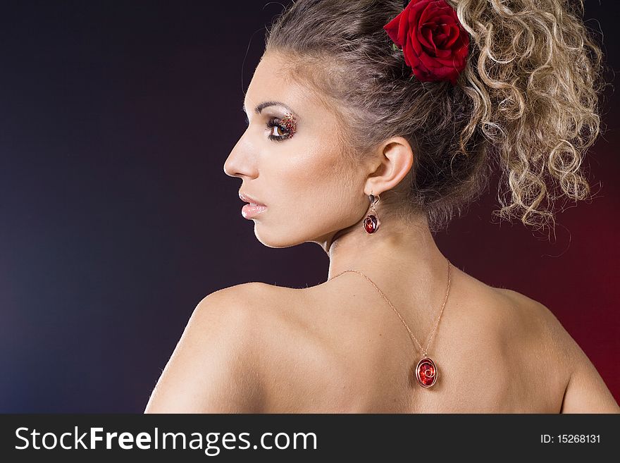 Beautiful fashionable woman with red rose